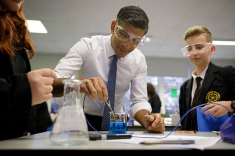 Rishi Sunak joining a chemistry during a visit to Erasmus Darwin academy in Burntwood, Staffordshire, today.