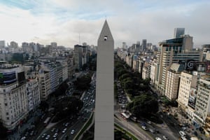 A view of someone looking out of a window of the Obelisk, with a large park and buildings in the background