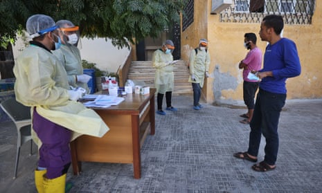 Syrian health workers stand at the entrance of the Ariha medical centre treating Covid-19 patients in the rebel-held northwestern Syrian province of Idlib, where cases of Covid-19 have increased alarmingly over the past month.