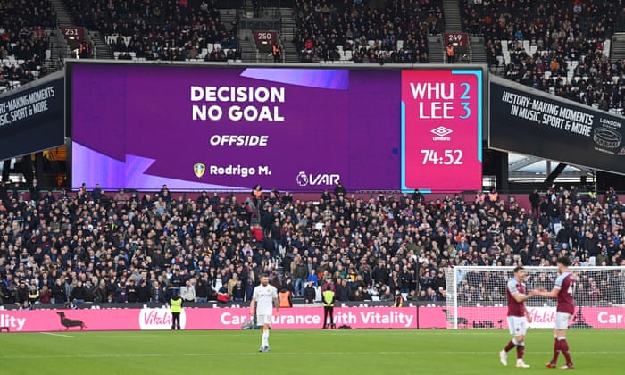 A VAR decision to disallow a Leeds goal shows on the big screen.