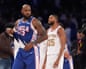 LeBron James walks past New York Knicks guard Mikal Bridges after helping the Philadelphia 76ers to a 106-100 victory in their NBA season opener at Madison Square Garden on Tuesday.