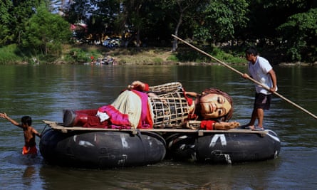 Little Amal crosses the Suchiate River on a raft, in Ciudad Hidalgo, state of Chiapas, Mexico.