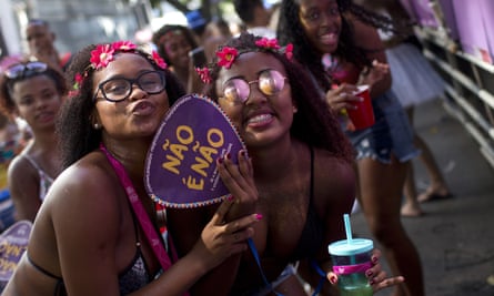 A woman holds a fan that reads ‘No is no’ during carnival celebrations in Rio