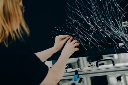 A Rolls-Royce specialist threads individual starlights into a car’s ceiling panel