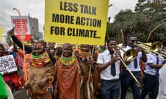 Turkana women, from north-west Kenya, hold a placard as they take part in a march in Nairobi on Monday. Activists of various nationalities urged delegates attending the Africa Climate Summit in Nairobi to engage actively in discussions to expedite the phase-out of fossil fuels