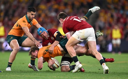 Harry Potter of the Wallabies is tackled by Tadhg Beirne (left) and Tommy Freeman of the Lions during the tourists’ first Test success.
