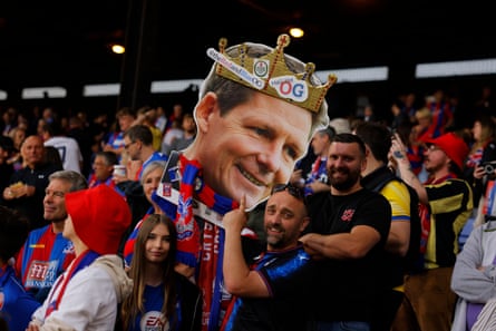Palace fans hold up a cutout of Oliver Glasner
