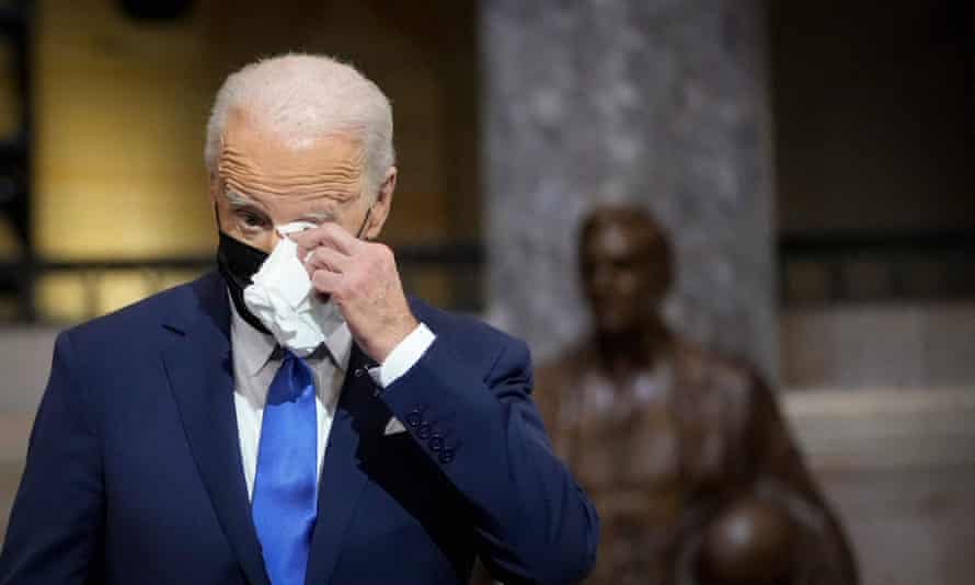 Biden wipes away a tear as he listens to Kamala Harris’s speech.