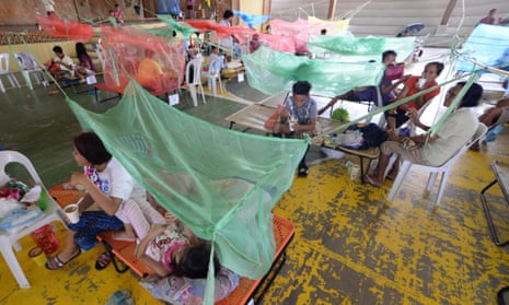 Patients suffering from dengue fever in a makeshift hospital in Maasin in the Philippine province of Iloilo.