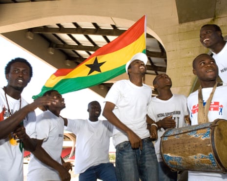 Sports fans in Accra, Ghana waving the national flag.