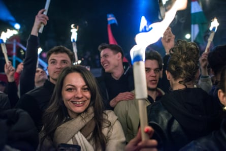 Supporters of the Tisza celebrate at an election night rally, central Budapest.