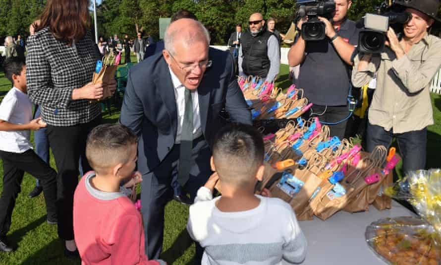 Prime minister Scott Morrison hands out lolly bags after Eid prayers to mark the end of Muslim Ramadan