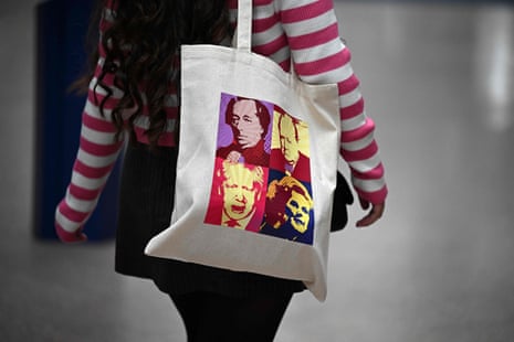A woman at the Tory conference carrying a big featuring pictures of former party leaders.