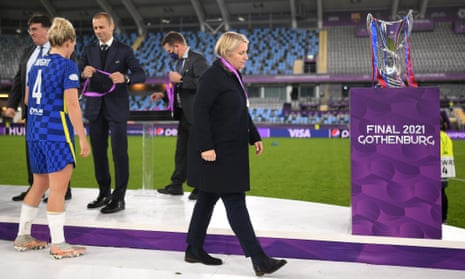 Emma Hayes looks dejected as she walks past the UEFA Women's Champions League trophy after defeat in the final