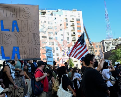 protestors hold signs and flags