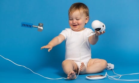 Smiling baby with a several gadgets