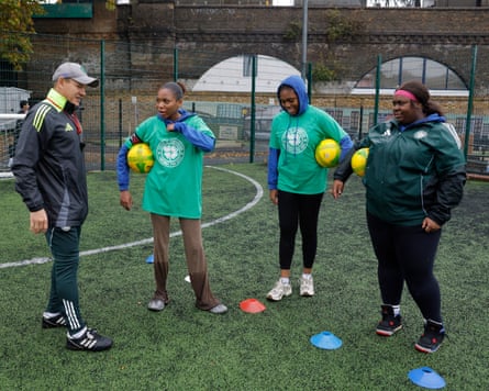 Vladyslav Kysil, Lucky Saunders, Sarah-Shalohm Griffith and Nygoni Thompson chat during a girls football tournament hosted by the Celtic FC Foundation at the Ferndale Sports Centre in Brixton
