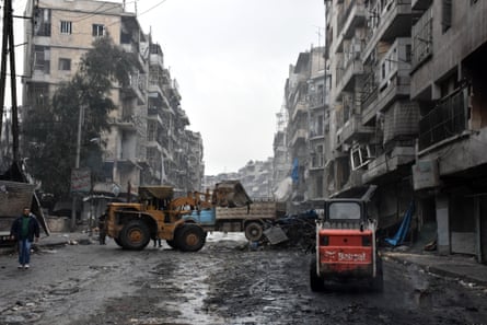 A tractor removes rubble as the Syrian government starts to clean up areas formerly held by opposition forces in the northern city of Aleppo.