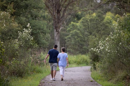 Michael and Kathy Strong walking along a path through bushland
