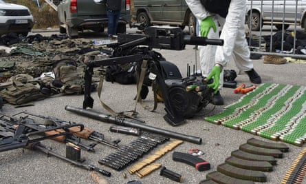 A Kosovo police officer displays weapons and military equipment, seized during the police operation in the village of Banjska.