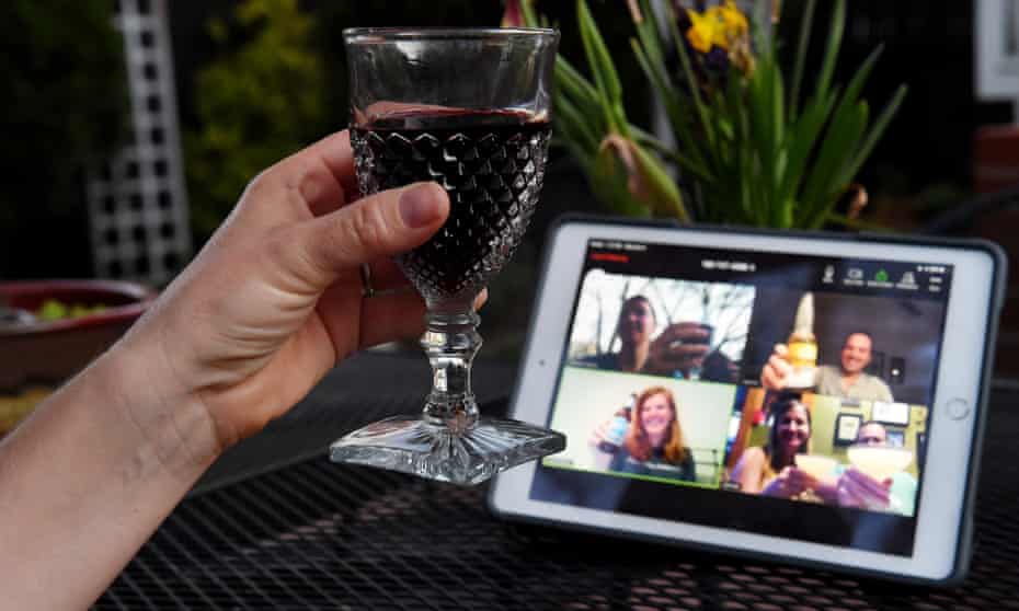 A woman lifts her glass and cheers with friends during a virtual happy hour amid the coronavirus crisis on 8 April 2020, in Arlington, Virginia.