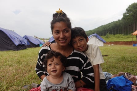 A woman sitting with two children