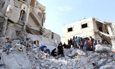 Syrian civil defence members and civilians search for survivors under the rubble of a site hit by airstrikes in the town of Kafr Takharim.