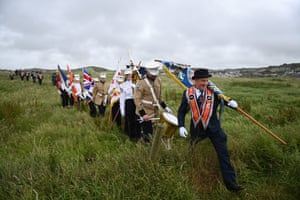 Orange Order members make their way through a field