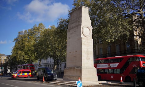 police travel warnings The Cenotaph monument on Whitehall, 5 November 2023, with red London bus and police van in background