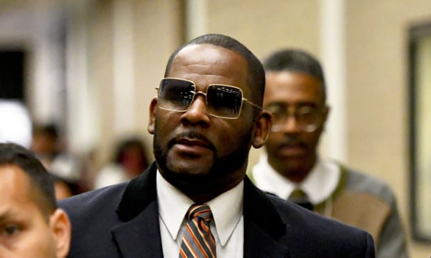 FILE - Musician R. Kelly, center, leaves the Daley Center after a hearing in his child support case on May 8, 2019, in Chicago. Closing arguments are scheduled Monday, Sept. 12, 2022 for R. Kelly and two co-defendants in the R&B singer’s trial on federal charges of trial-fixing, child pornography and enticing minors for sex, with jury deliberations to follow. (AP Photo/Matt Marton, File)