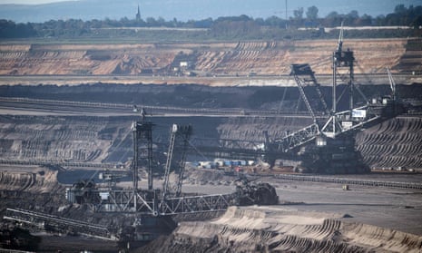 Bucket wheel excavators dig into the earth at the Garzweiler open pit lignite mine in western Germany