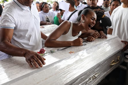 People weeping over a sliver coffin