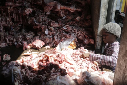 A woman scavenges through through animal carcasses for food in Rio de Janeiro.