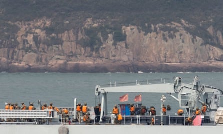 Soldiers stand on the deck of a Chinese warship as it sails during a military drill near Fuzhou, Fujian province, near the Taiwan-controlled Matsu Islands.