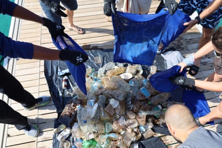 The divers put the rubbish collected into a large pile on the boat deck 