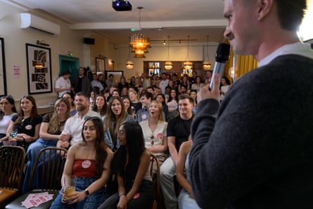 A crowd of women and men in a pub in London at a dating event