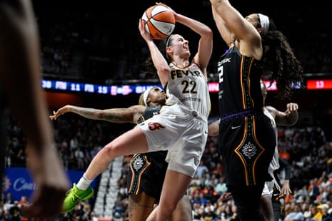 Indiana guard Caitlin Clark (22) is fouled from behind by Connecticut guard Tiffany Mitchell (3) as she drives against forward Brionna Jones (42) on Tuesday night.