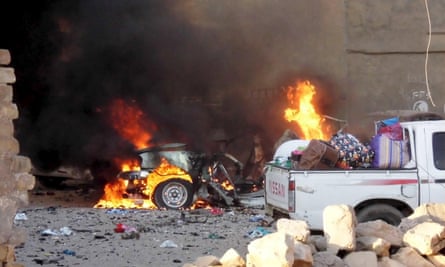 A car is engulfed by flames during clashes in the city of Ramadi.