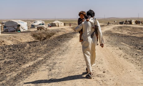 A displaced father and son walk towards the temporary tent settlement on the outskirts of Marib in central Yemen. More than 750,000 Yemenis have fled to the Marib region from villages and towns that are now controlled by Houthi forces.