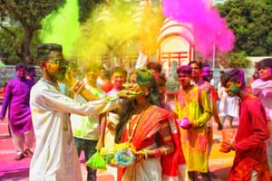 A couple daub each other with coloured powder at the Dhakeshwari national temple in Dhaka, Bangladesh.