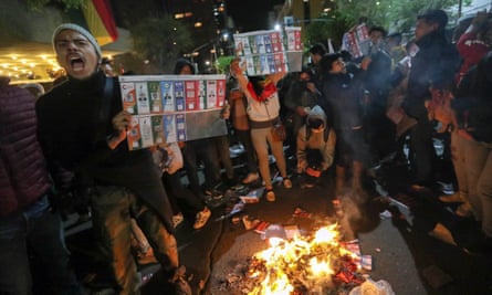 Supporters of the Bolivian opposition candidate Carlos Mesa of Comunidad Ciudadana party burn ballots during a protest in La Paz.