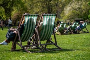 People relax in the sunshine at St James’ Park, with temperatures set to rise in parts of the UK