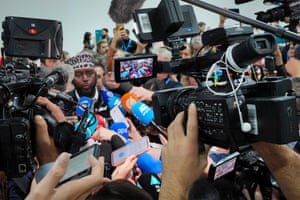 Mohamed Adow at the centre of a media scrum