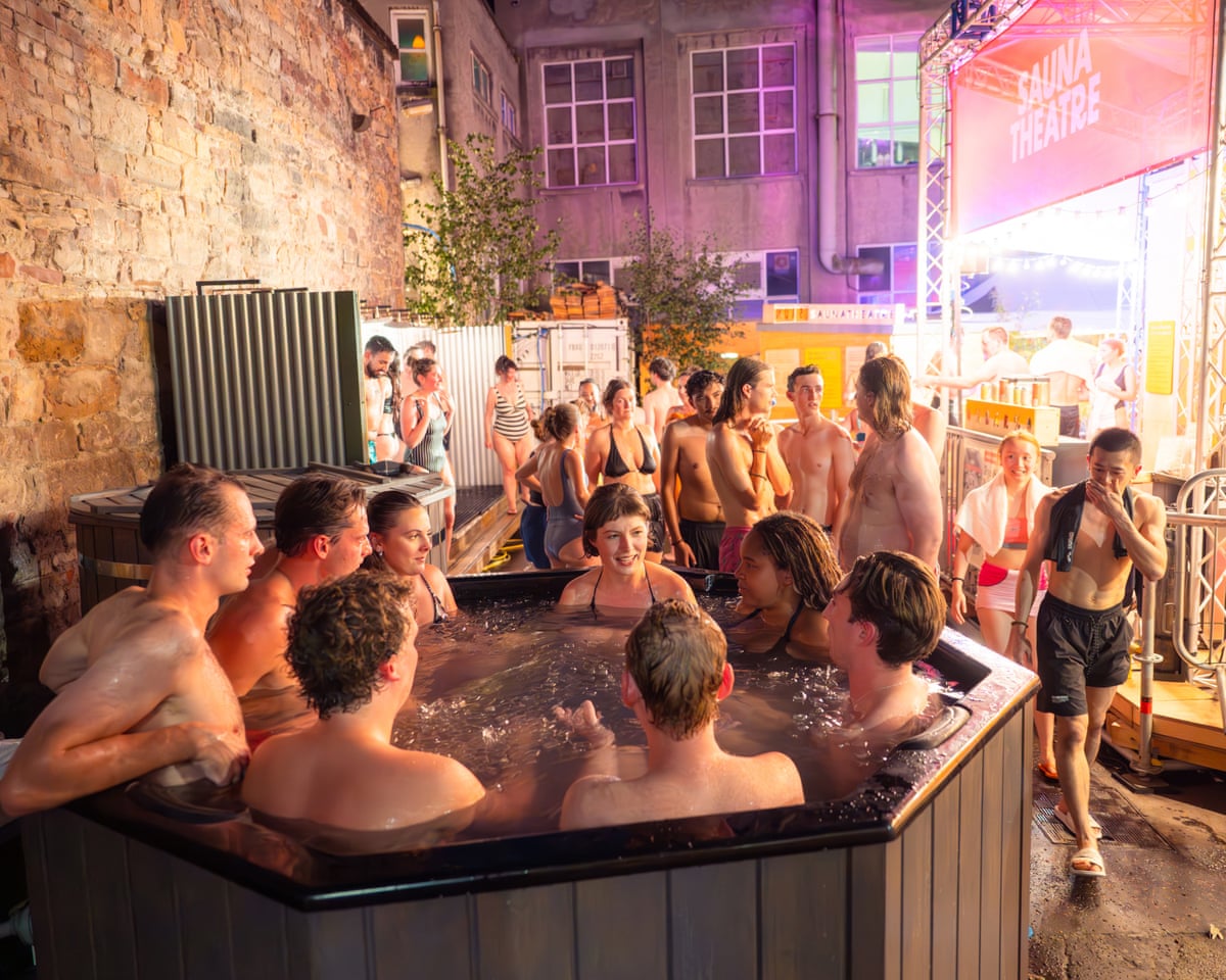A crowd of people, some in a hot tub.