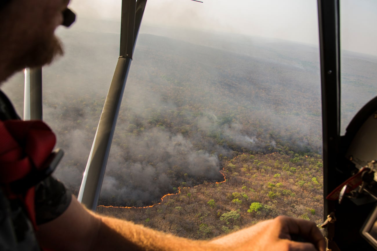 Cédric Ganière, one of the Chinko’s pilots, flies over a bushfire on the savannah in his tiny, two-seater plane during a mission to spot blazes lit by cattle herders.