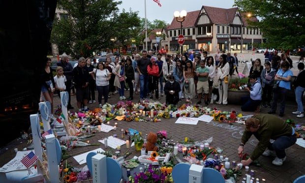 Mourners visit a memorial site after a mass shooting at a Fourth of July parade in the Chicago suburb of Highland Park