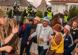 Mounted security personnel on horses behind Oasis fans.