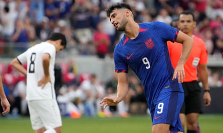 Ricardo Pepi, right, celebrates after scoring as Uzbekistan’s Jamshid Iskanderov is seen in the background during the second half of Saturday’s friendly in St Paul, Minnesota. Photograph: Jeff Roberson/AP