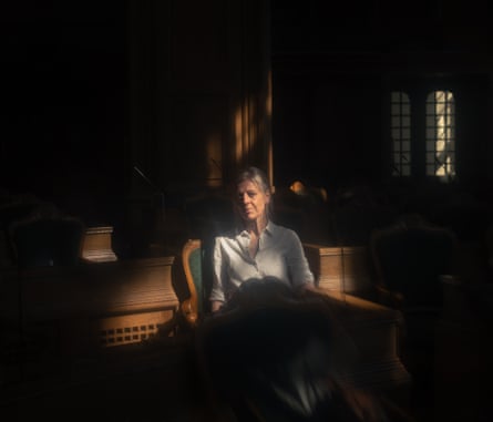 Trine Pertou Mach sitting in a chair, lit by the sun coming through a window beside her