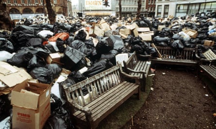 Bin bags and boxes around a park bench